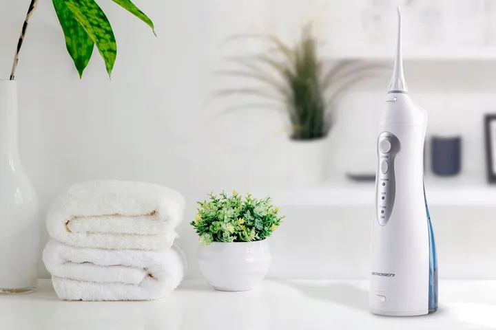Berdsen ClearJet X3 bezvadu irrigators vannasistabas vidē blakus dvieļiem un augu podiņam